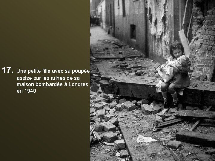 17. Une petite fille avec sa poupée assise sur les ruines de sa maison