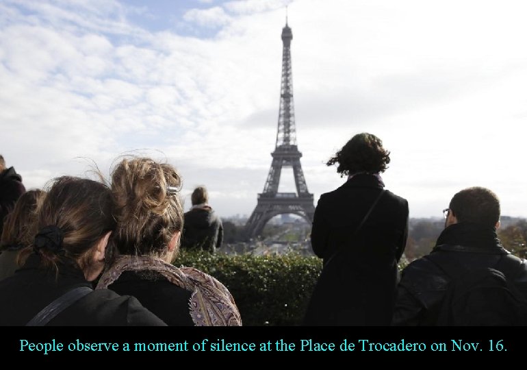 People observe a moment of silence at the Place de Trocadero on Nov. 16.