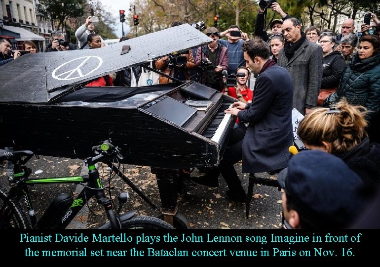 Pianist Davide Martello plays the John Lennon song Imagine in front of the memorial