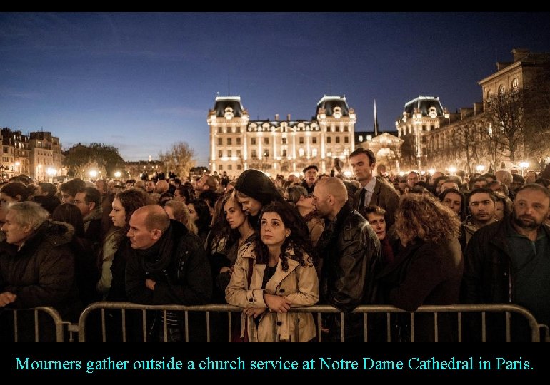 Mourners gather outside a church service at Notre Dame Cathedral in Paris. 