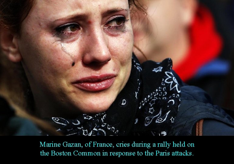 Marine Gazan, of France, cries during a rally held on the Boston Common in