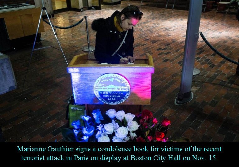 Marianne Gauthier signs a condolence book for victims of the recent terrorist attack in