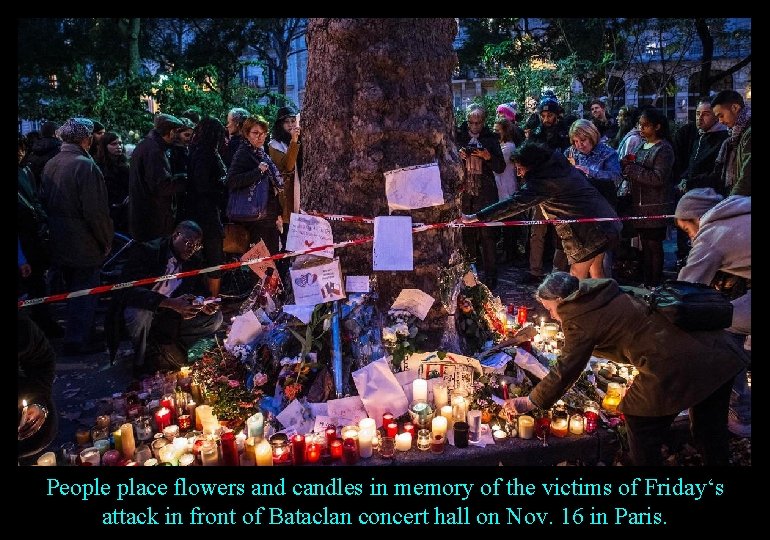 People place flowers and candles in memory of the victims of Friday‘s attack in