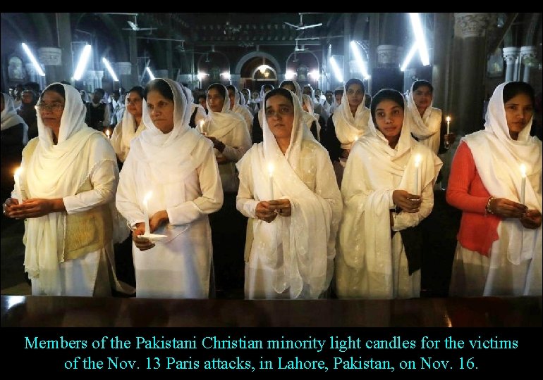 Members of the Pakistani Christian minority light candles for the victims of the Nov.