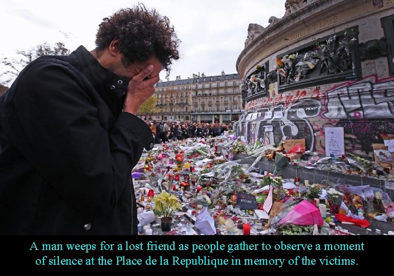 A man weeps for a lost friend as people gather to observe a moment