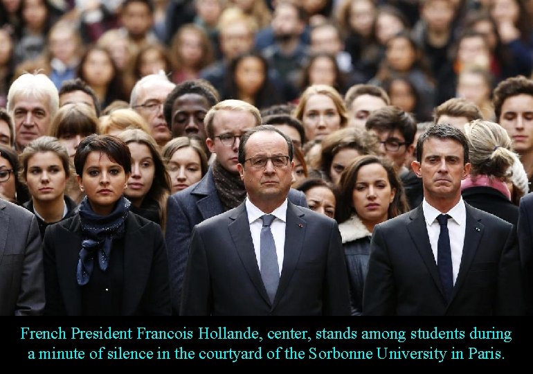French President Francois Hollande, center, stands among students during a minute of silence in