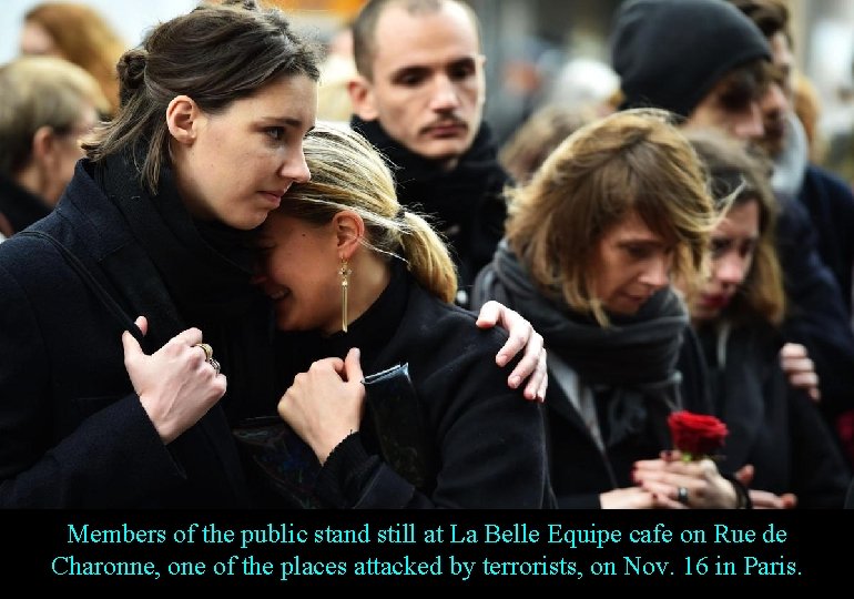 Members of the public stand still at La Belle Equipe cafe on Rue de