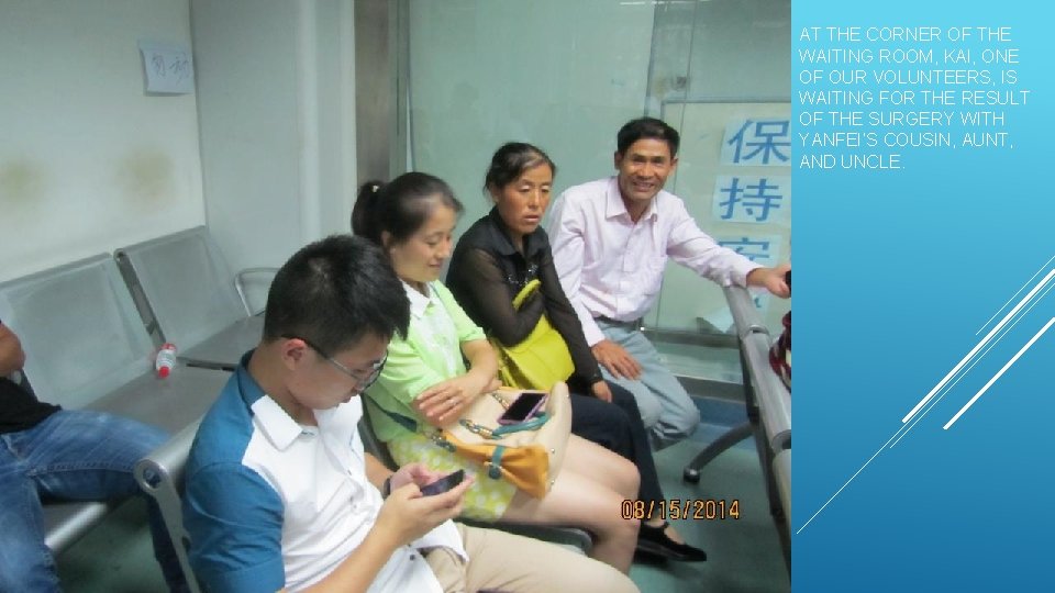 AT THE CORNER OF THE WAITING ROOM, KAI, ONE OF OUR VOLUNTEERS, IS WAITING