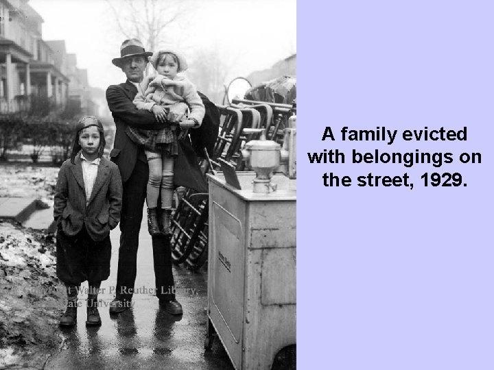 A family evicted with belongings on the street, 1929. 