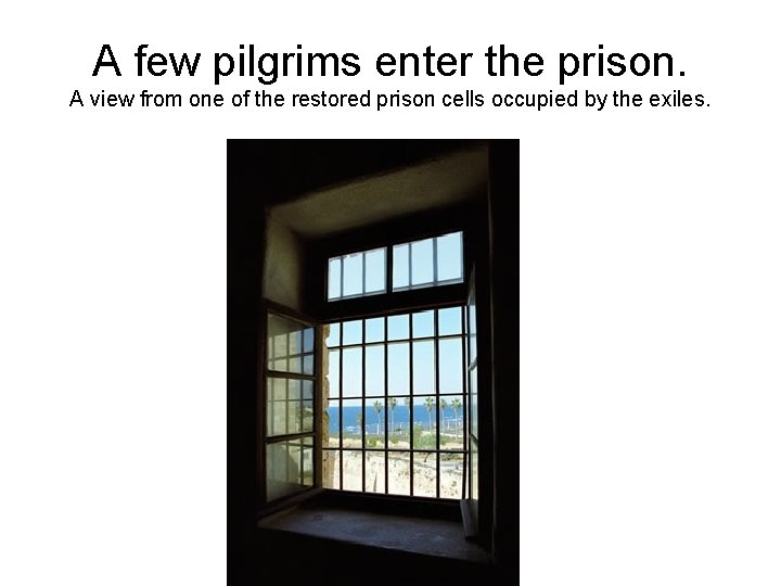 A few pilgrims enter the prison. A view from one of the restored prison
