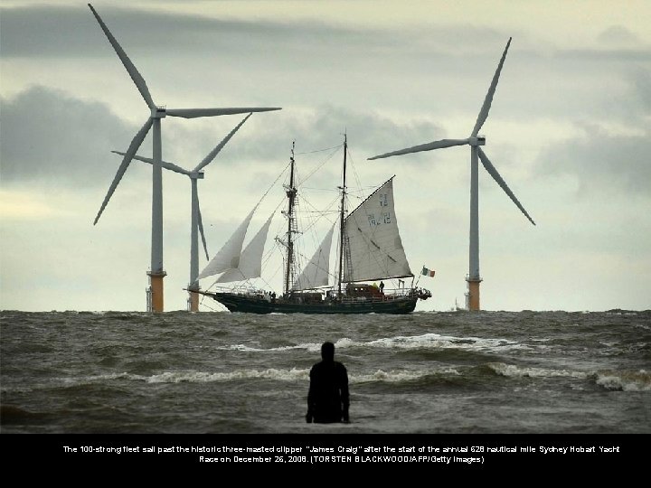 The 100 -strong fleet sail past the historic three-masted clipper "James Craig" after the