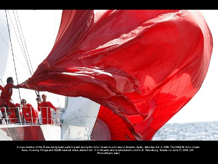 A crew member of the Puma racing team pulls in a sail during the