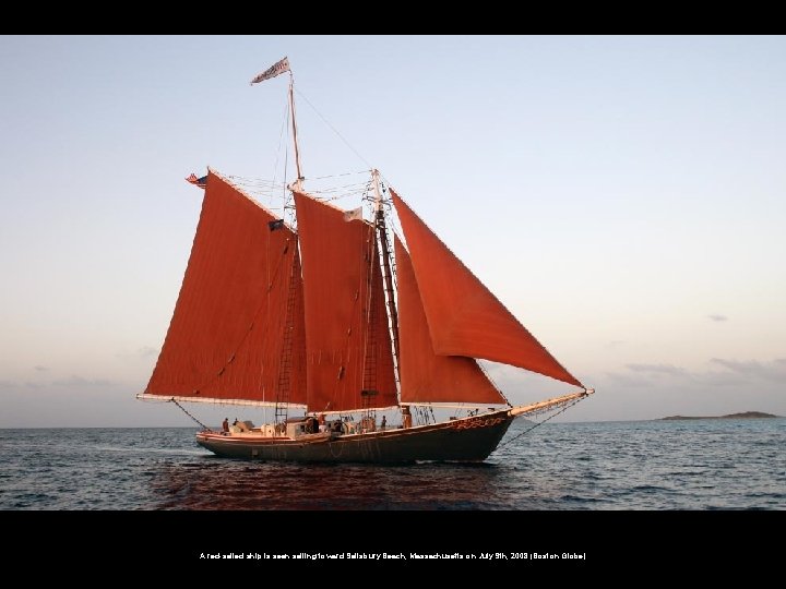 A red-sailed ship is seen sailing toward Salisbury Beach, Massachusetts on July 9 th,