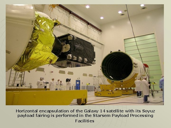 Horizontal encapsulation of the Galaxy 14 satellite with its Soyuz payload fairing is performed