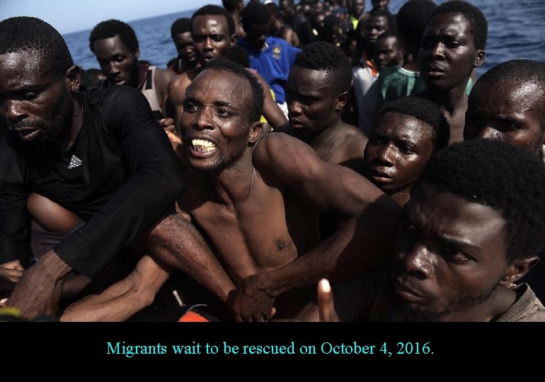 Migrants wait to be rescued on October 4, 2016. 