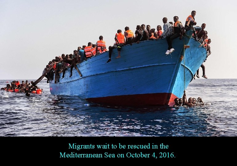 Migrants wait to be rescued in the Mediterranean Sea on October 4, 2016. 