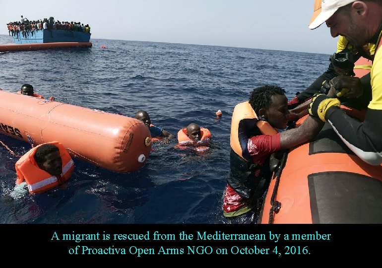 A migrant is rescued from the Mediterranean by a member of Proactiva Open Arms