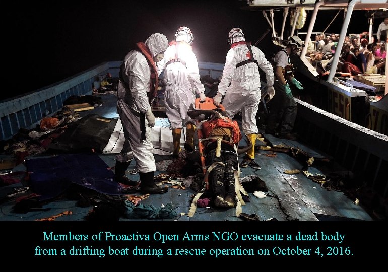 Members of Proactiva Open Arms NGO evacuate a dead body from a drifting boat