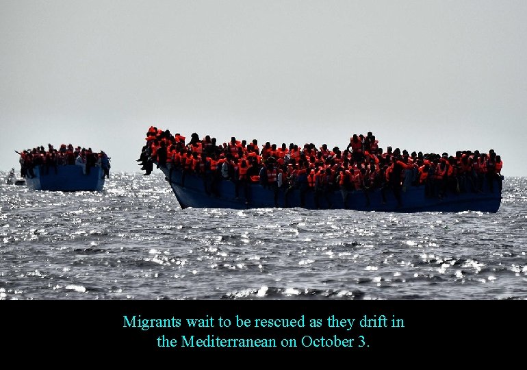 Migrants wait to be rescued as they drift in the Mediterranean on October 3.