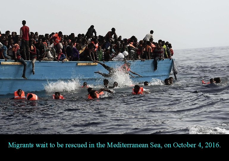 Migrants wait to be rescued in the Mediterranean Sea, on October 4, 2016. 