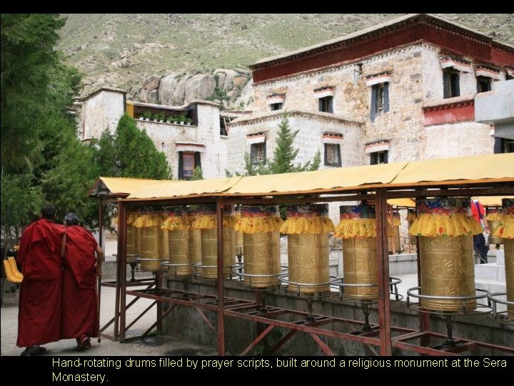 Hand-rotating drums filled by prayer scripts, built around a religious monument at the Sera Hand-rotating drums filled by prayer scripts, built around a religious monument at the Sera