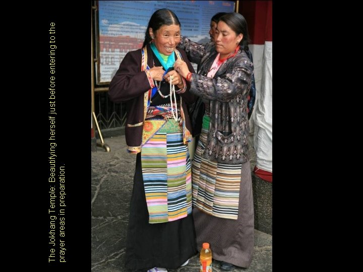 The Jokhang Temple: Beautifying herself just before entering to the prayer areas in preparation. The Jokhang Temple: Beautifying herself just before entering to the prayer areas in preparation.