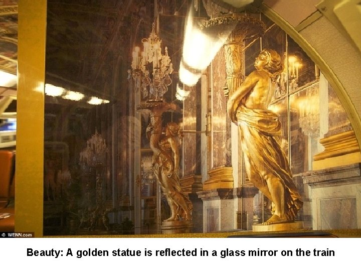 Beauty: A golden statue is reflected in a glass mirror on the train 