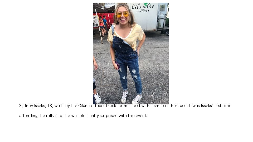 Sydney Isseks, 18, waits by the Cilantro Tacos truck for her food with a