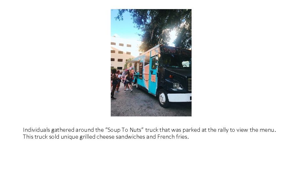Individuals gathered around the “Soup To Nuts” truck that was parked at the rally