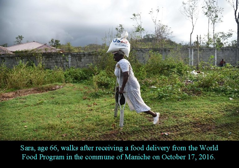 Sara, age 66, walks after receiving a food delivery from the World Food Program