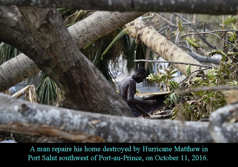 A man repairs his home destroyed by Hurricane Matthew in Port Salut southwest of