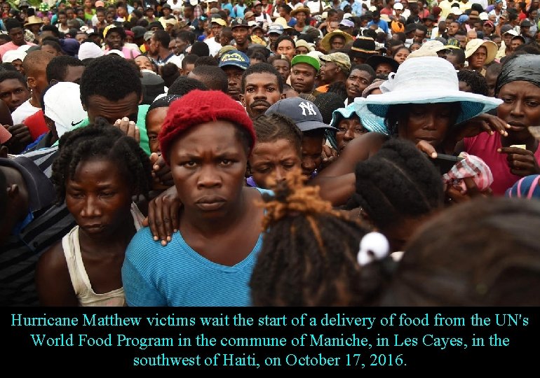 Hurricane Matthew victims wait the start of a delivery of food from the UN's