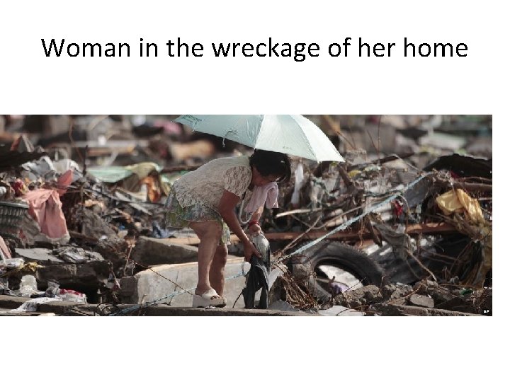 Woman in the wreckage of her home 