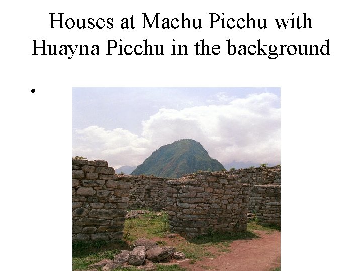 Houses at Machu Picchu with Huayna Picchu in the background • 