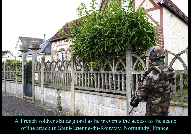 A French soldier stands guard as he prevents the access to the scene of