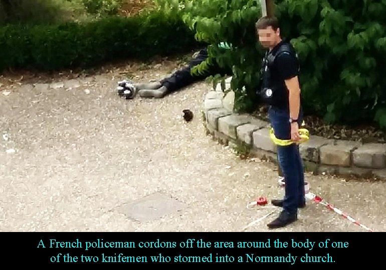 A French policeman cordons off the area around the body of one of the