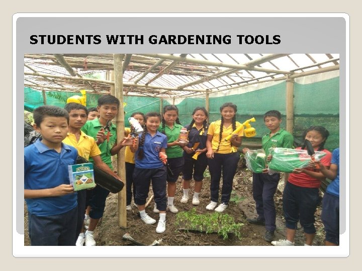 STUDENTS WITH GARDENING TOOLS 