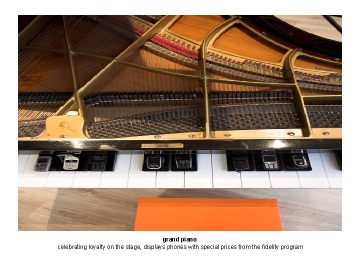 grand piano celebrating loyalty on the stage, displays phones with special prices from the