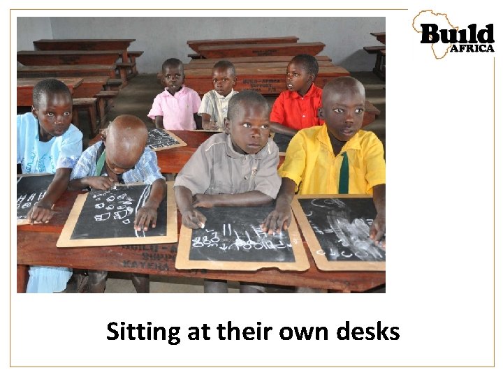 Sitting at their own desks 