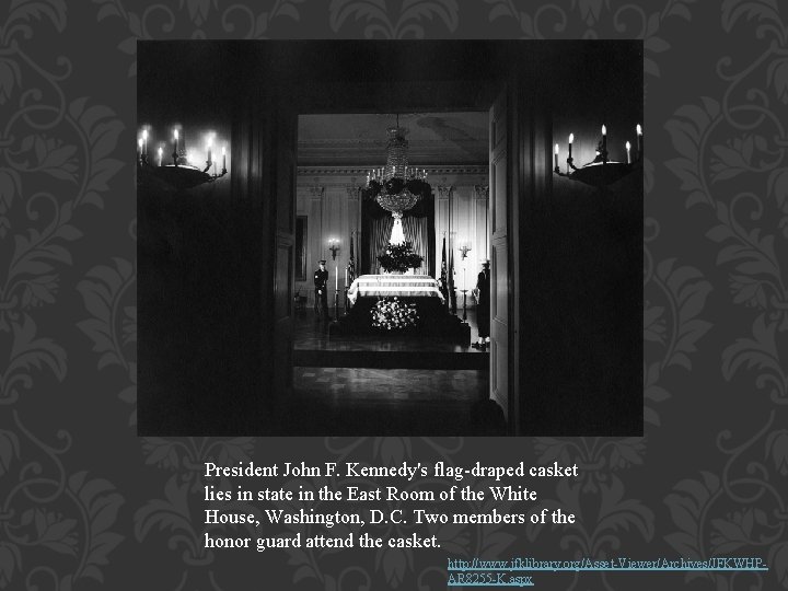 President John F. Kennedy's flag-draped casket lies in state in the East Room of