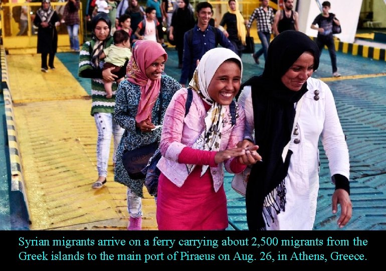 Syrian migrants arrive on a ferry carrying about 2, 500 migrants from the Greek