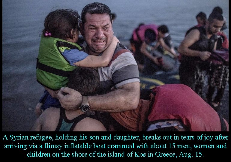 A Syrian refugee, holding his son and daughter, breaks out in tears of joy