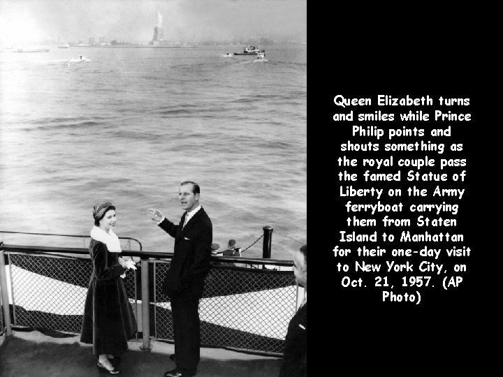 Queen Elizabeth turns and smiles while Prince Philip points and shouts something as the