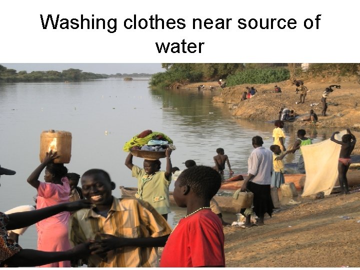 Washing clothes near source of water 