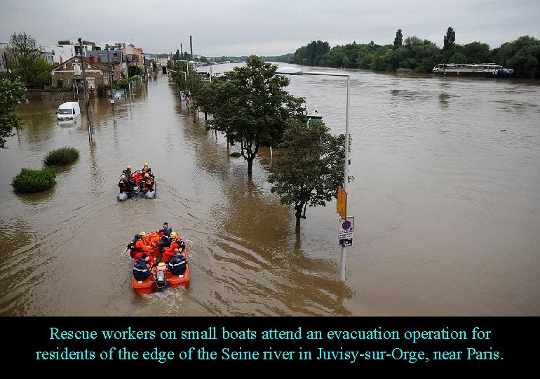 Rescue workers on small boats attend an evacuation operation for residents of the edge