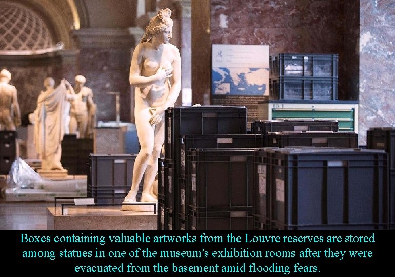 Boxes containing valuable artworks from the Louvre reserves are stored among statues in one