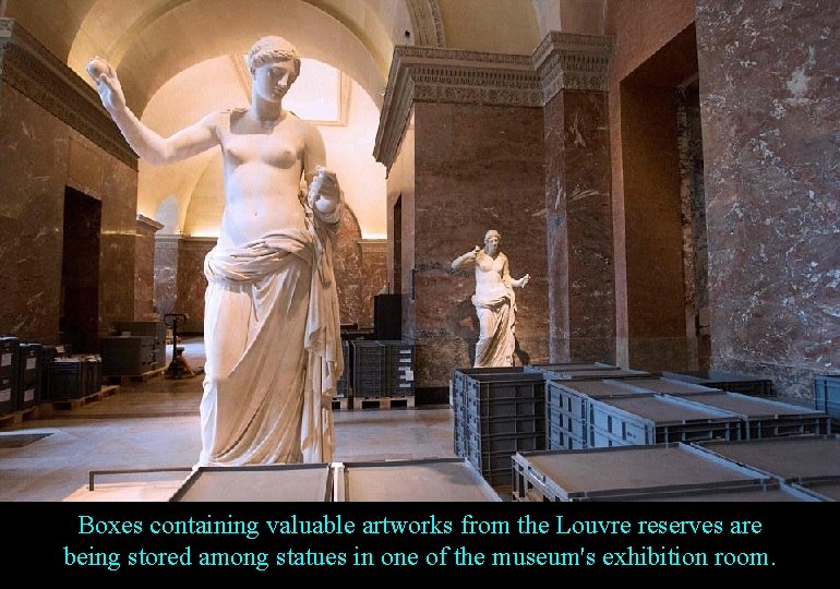 Boxes containing valuable artworks from the Louvre reserves are being stored among statues in