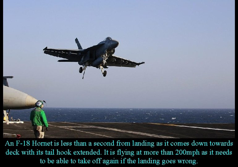 An F-18 Hornet is less than a second from landing as it comes down