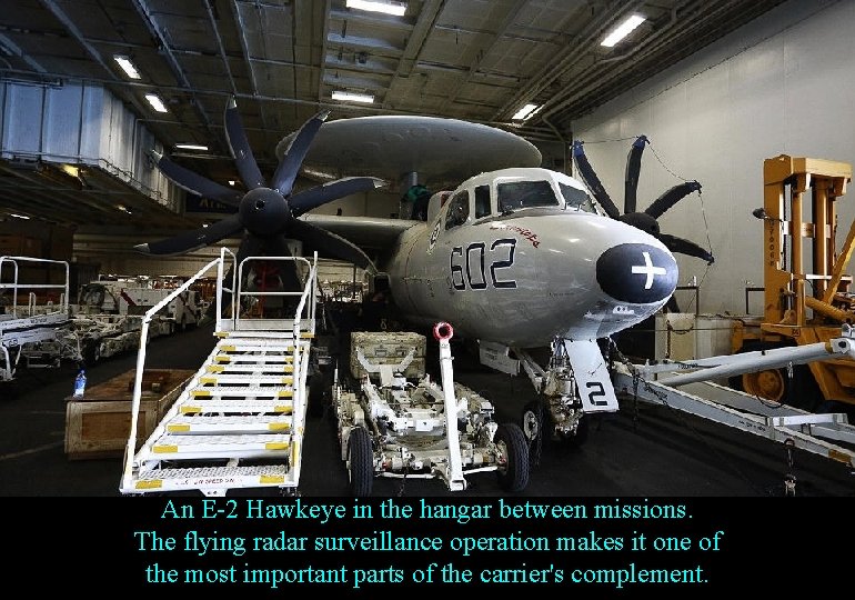 An E-2 Hawkeye in the hangar between missions. The flying radar surveillance operation makes