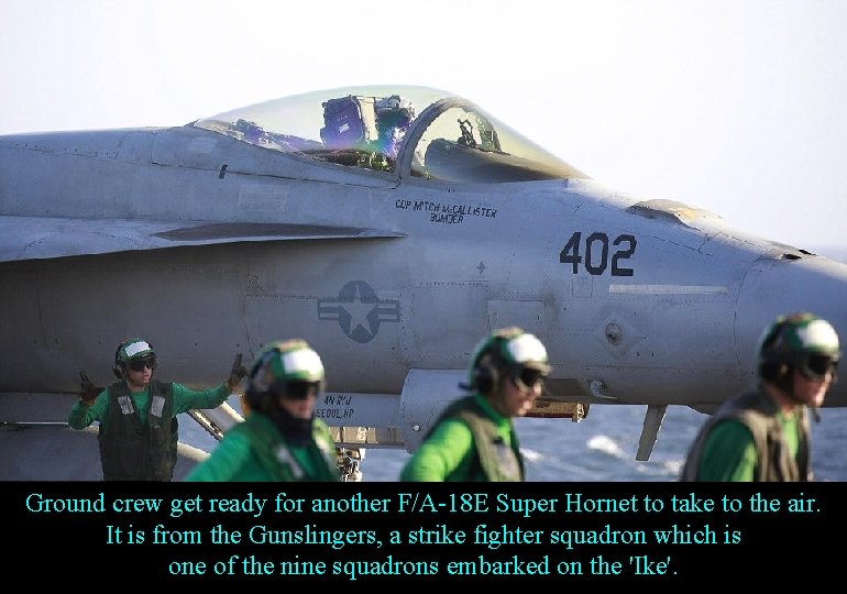 Ground crew get ready for another F/A-18 E Super Hornet to take to the